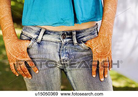 Mid section view of a young woman with her henna tattooed hands View Large Photo Image Stock Photo - Mid section view of a young woman with her henna tattooed hands. Fotosearch