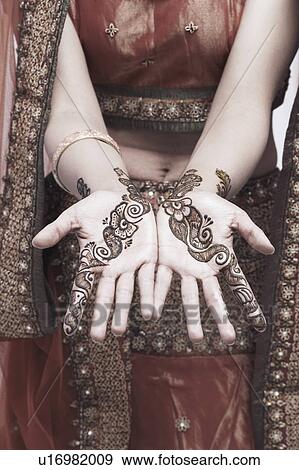 Mid section view of a young woman with henna tattoo's on her hands View Large Photo Image Stock Photo - Mid section view of a young woman with henna tattoo's on her hands. Fotosearch