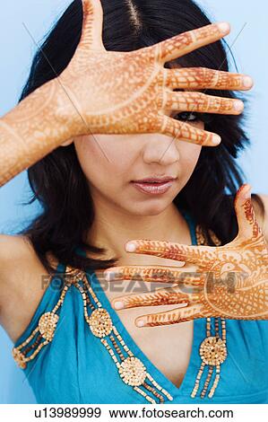 Portrait of a young woman showing henna tattoo on her hands View Large Photo Image Stock Photo - Portrait of a young woman showing henna tattoo on her hands. Fotosearch
