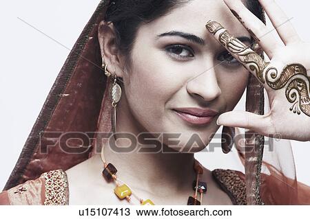Portrait of a young woman with henna tattoo's on her hand View Large Photo Image Stock Image - Portrait of a young woman with henna tattoo's on her hand. Fotosearch