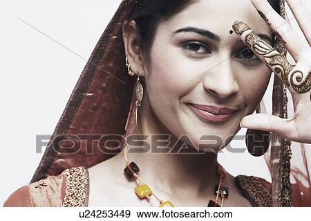 Portrait of a young woman with henna tattoo's on her hand View Large Photo Image Stock Photo - Portrait of a young woman with henna tattoo's on her hand. Fotosearch