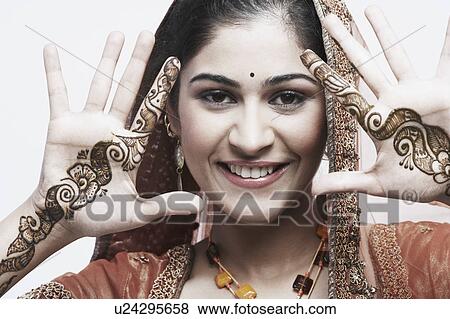Portrait of a young woman with henna tattoo's on her hands View Large Photo Image Stock Photo - Portrait of a young woman with henna tattoo's on her hands. Fotosearch