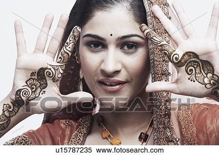Stock Photography - Portrait of a young woman with henna tattoo's on her hands. Fotosearch