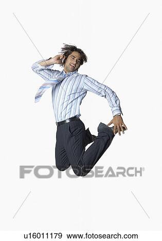 Stock Photo - Businessman jumping and talking on a mobile phone. Fotosearch
