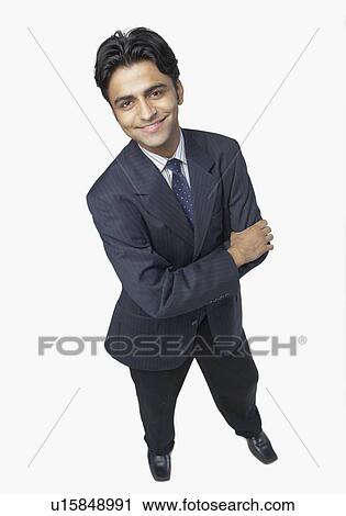 High angle view of a businessman standing with his arms crossed and smiling View Large Photo Image Stock Image - High angle view of a businessman standing with his arms crossed and smiling. Fotosearch