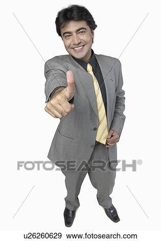 Stock Photo - High angle view of a businessman showing a thumbs up sign. Fotosearch
