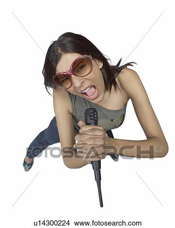 High angle view of a young woman singing into a microphone View Large Photo Image Picture - High angle view of a young woman singing into a microphone. Fotosearch