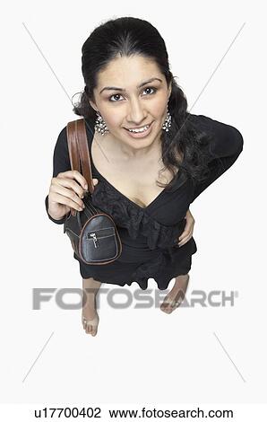 High angle view of a young woman smiling View Large Photo Image Stock Image - High angle view of a young woman smiling. Fotosearch