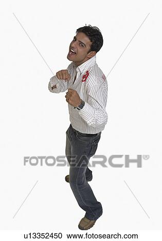 Portrait of a young man clenching his fist View Large Photo Image Stock Image - Portrait of a young man clenching his fist. Fotosearch