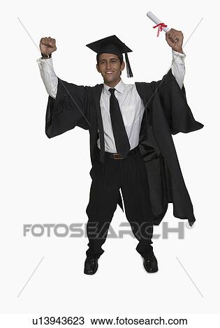 Stock Image - Portrait of a young man holding a diploma and smiling. Fotosearch