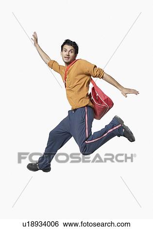 Stock Photograph - Portrait of a young man jumping. Fotosearch