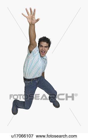 Portrait of a young man shouting with his hand raised View Large Photo Image Stock Photo - Portrait of a young man shouting with his hand raised. Fotosearch