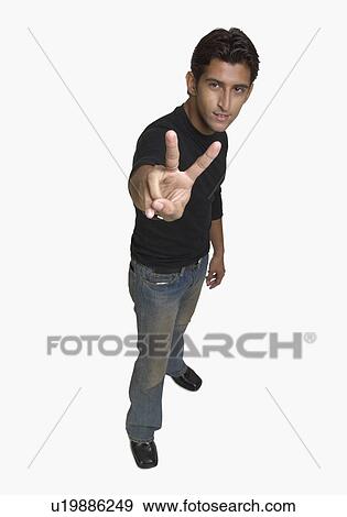 Portrait of a young man showing the peace sign View Large Photo Image Stock Photo - Portrait of a young man showing the peace sign. Fotosearch