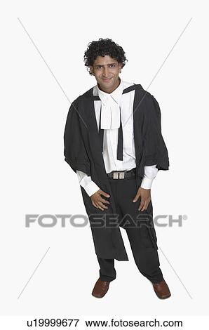 Stock Photo - Portrait of a young man smiling in a graduation gown. Fotosearch