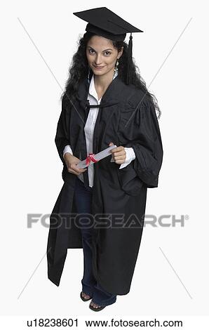 Portrait of a young woman holding a diploma and smiling View Large Photo Image Stock Image - Portrait of a young woman holding a diploma and smiling. Fotosearch