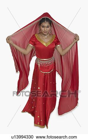 Portrait of a young woman in traditional Indian clothing View Large Photo Image Stock Image - Portrait of a young woman in traditional Indian clothing. Fotosearch