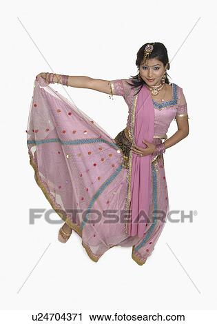 Portrait of a young woman posing in traditional Indian clothing View Large Photo Image Stock Image - Portrait of a young woman posing in traditional Indian clothing. Fotosearch