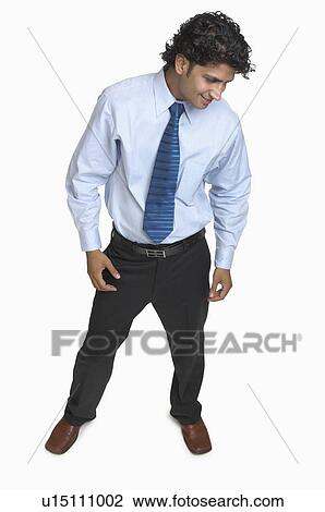 Stock Image - Young man standing and smiling. Fotosearch