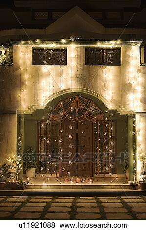 Stock Photo - Decorated entrance of a house lit up at night. Fotosearch