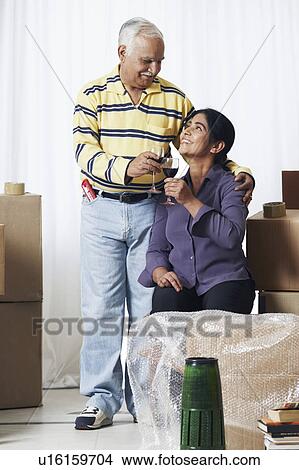 Mature couple raising a toast View Large Photo Image Picture - Mature couple raising a toast. Fotosearch