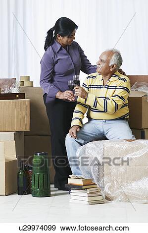 Stock Photo - Mature couple raising a toast. Fotosearch