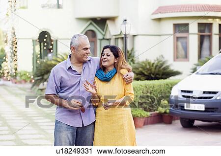 Mid adult couple standing together and smiling View Large Photo Image Stock Image - Mid adult couple standing together and smiling. Fotosearch