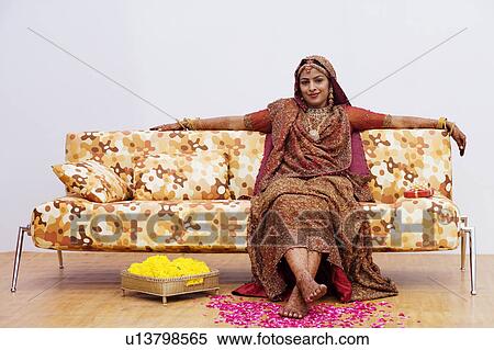 Stock Photography - Portrait of a bride sitting on a couch. Fotosearch