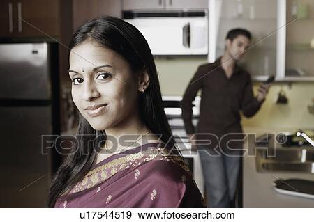 Portrait of a young couple in the kitchen View Large Photo Image Stock Photo - Portrait of a young couple in the kitchen. Fotosearch