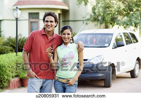 Portrait of a young couple standing together and smiling View Large Photo Image Stock Image - Portrait of a young couple standing together and smiling. Fotosearch
