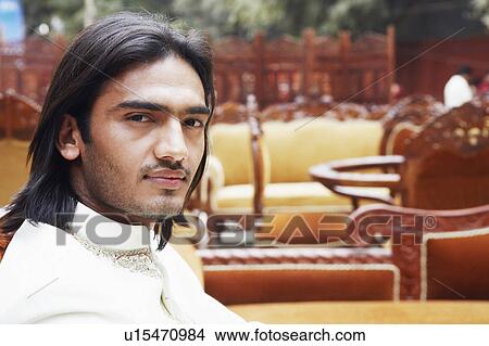 Portrait of a young man in a furniture store View Large Photo Image Picture - Portrait of a young man in a furniture store. Fotosearch