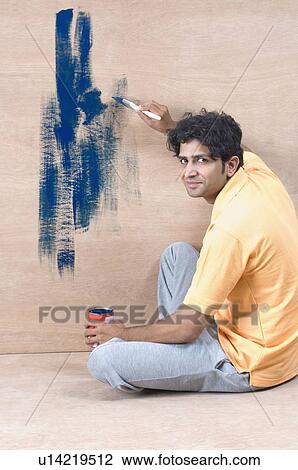 Portrait of a young man painting a wall View Large Photo Image Stock Image - Portrait of a young man painting a wall. Fotosearch