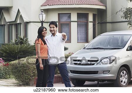 Stock Image - Portrait of a young man standing with a young woman. Fotosearch