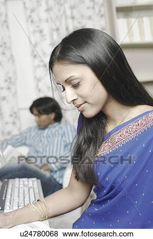 Stock Photo - Side profile of a young woman looking down. Fotosearch