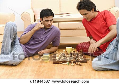 Two young men playing chess View Large Photo Image Stock Photo - Two young men playing chess. Fotosearch