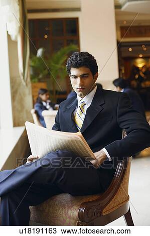 Stock Image - Businessman reading a newspaper. Fotosearch