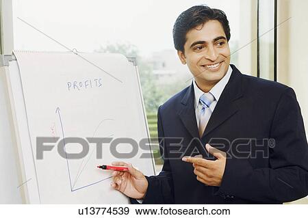 Close-up of a businessman explaining on a whiteboard View Large Photo Image Stock Photo - Close-up of a businessman explaining on a whiteboard. Fotosearch