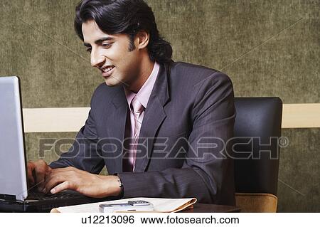 Stock Photograph - Close-up of a businessman using a laptop. Fotosearch