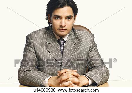 Portrait of a businessman with his hands clasped View Large Photo Image Stock Image - Portrait of a businessman with his hands clasped. Fotosearch