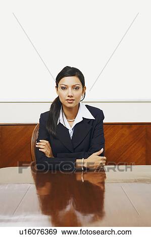 Stock Photo - Portrait of a businesswoman sitting in a conference room. Fotosearch
