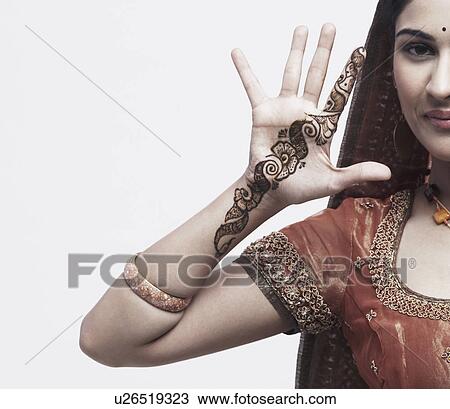 Portrait of a young woman with henna tattoo's on her hand View Large Photo Image Stock Image - Portrait of a young woman with henna tattoo's on her hand. Fotosearch