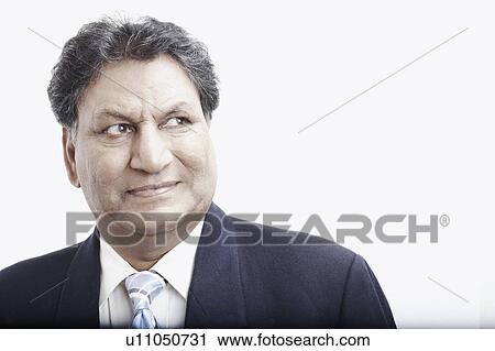 Stock Image - Close-up of a businessman looking serious. Fotosearch