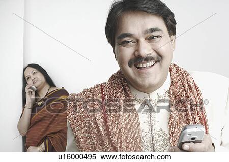 Stock Photography - Close-up of a mature man standing in front of a mature woman. Fotosearch
