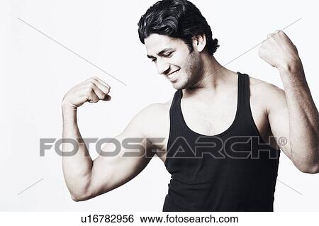 Stock Photograph - Close-up of a young man flexing his muscles. Fotosearch