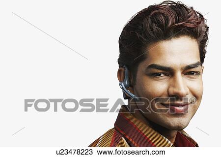 Portrait of a young man wearing a headset View Large Photo Image Stock Image - Portrait of a young man wearing a headset. Fotosearch