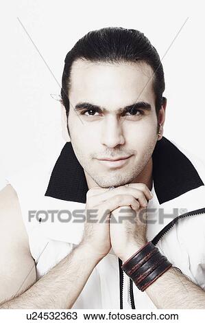 Portrait of a young man with his hands under his chin View Large Photo Image Stock Image - Portrait of a young man with his hands under his chin. Fotosearch
