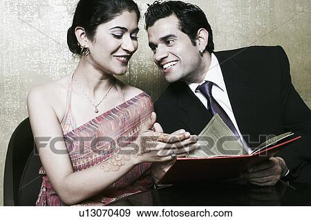 Stock Photo - Close-up of a businessman and a businesswoman smiling. Fotosearch