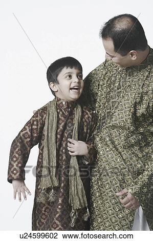 Close-up of a father and his son looking at each other View Large Photo Image Stock Image - Close-up of a father and his son looking at each other. Fotosearch