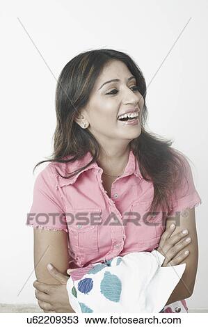 Stock Image - Close-up of a mid adult woman with her arms crossed. Fotosearch