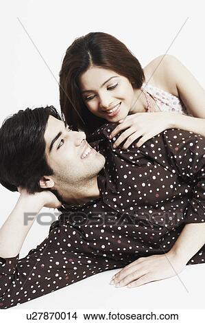 Picture - Close-up of a young couple smiling. Fotosearch