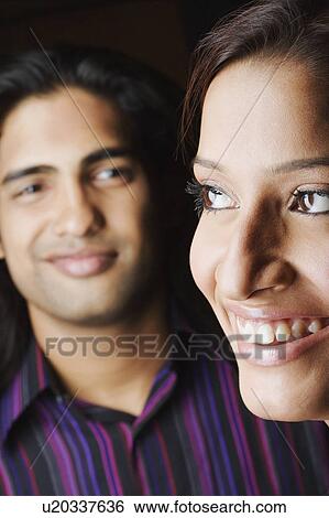 Stock Photograph - Close-up of a young couple smiling. Fotosearch